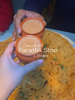 Enjoying a variety of flavorful desi dishes at Paratha Stop, including channa paratha, samosa chaat, tea, and a mojito.