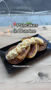 The creator visits three different venues in Dundee—Black Mamba, Jute Cafe, and Beans & Berries—to sample their pancake offerings using the Dundee Gift Card. The video follows a listicle format, showing the exterior of each venue, the payment process, and close-ups of the pancake dishes, with the creator providing commentary on each.