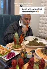 A vlog-style review of Rice Club in East Ham, highlighting the restaurant's interior, theatrical food presentation, and family-friendly environment, specifically noting its suitability for Iftar during Ramadan.