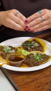 A short, energetic video showcasing a Mexican street food stall called Guacamoles located in a market in Peckham. The video highlights the affordability of the food, specifically the tacos and guacamole, while capturing the casual, social atmosphere of the market setting.