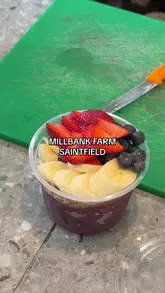 The creator visits Millbank Farm in Saintfield, providing a tour of the farm shop's local produce, bakery items, and the newly opened cafe section. The video highlights the connection between the fresh ingredients in the shop and the menu items like acai bowls and smoothies.