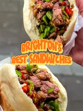 The creator visits Shaanxi in Brighton to review their Roujiamo (Chinese burger). The video features the creator talking to the camera, interspersed with B-roll footage of the kitchen staff preparing the dough and meat from scratch, followed by the creator's taste test and verdict.