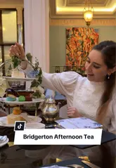 A short, aesthetic reel showcasing a Bridgerton-themed afternoon tea service at The Lanesborough. The video features close-up shots of the tea service, pastries, and the elegant venue interior, overlaid with a 'Bridgerton name generator' game to encourage viewer interaction.
