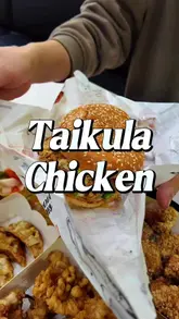 A food review video showcasing various Taiwanese-style fried chicken dishes, including nuggets, gizzards, chicken claws, squid tentacles, gyoza, and a chicken burger at Taikula Chicken in Brick Lane.