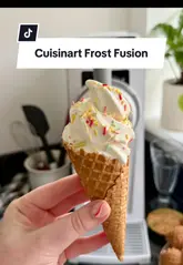 A tutorial video demonstrating the Cuisinart Frost Fusion machine, showing the process of making soft-serve ice cream and a frozen latte at home.