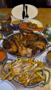 A review of a new French-inspired chicken restaurant called Le Coq Boutique, showcasing their roast chicken, sides, and cocktails.