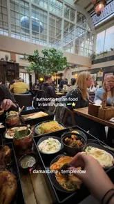 A short, energetic video showcasing a visit to Damascena in Birmingham. The footage captures the restaurant's interior, a table filled with a variety of Syrian dishes including dips, flatbreads, grilled meats, and desserts, as well as refreshing drinks.