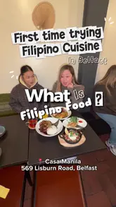 A casual review video featuring two creators trying Filipino cuisine for the first time at Casa Manila in Belfast. The video includes dialogue about the dishes, close-ups of the food, and a brief appearance by the chef.