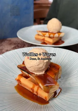 Delicious banana and ice cream waffles served with a vibrant cocktail at Waffles + Waves brunch club, St Andrews, Fife.