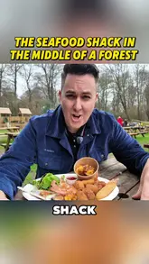 A vlog-style review of a seafood shack located in Epping Forest. The creator showcases the outdoor seating area, the menu items including a seafood platter, tempura prawns, and scallops, and provides an honest assessment of the food quality.