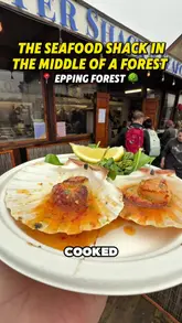 A review of the Oyster Shack & Seafood Bar in Epping Forest, highlighting its unique forest location, fresh daily seafood deliveries, and menu items like chilli and lime king scallops and mango-curried butterfly prawns.