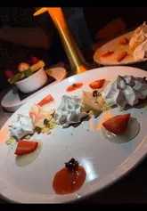 A vlog-style review of a dining deal at Mini Grill in Glasgow, highlighting the three-course menu with prosecco, followed by a visit to a theatre show. The video features close-ups of various dishes including haggis, beef burger, and desserts, alongside a demonstration of the booking app.