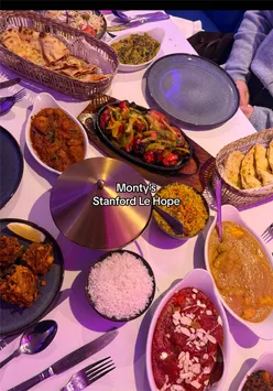 Here are a few options, choose the one that best reflects the specific image (e.g., if it shows multiple dishes vs. one main dish):

**Option 1 (General Spread):**
"Delicious Indian curry dishes, rice, and naan bread on a table at Montys curry house in Essex. Perfect for an Essex foodie." (122 characters)

**Option 2 (Focus on Key Dishes):**
"Mouth-watering Indian curry dishes, like chicken tikka and biryani, served at Montys curry house in Essex." (110 characters)

**Option 3 (Concise & Keyword-rich):**
"Plates of aromatic Indian curries, rice & naan at Montys, a recommended Essex curry house for foodies." (115 characters)