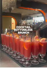 A fast-paced, first-person review of a bottomless brunch experience at a rooftop venue in London. The creator highlights the lively atmosphere, live music, and cocktail selection, while providing an honest critique of the food quality.