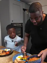 A father and son cook a fry-up breakfast at home while discussing an energy company's Sunday Saver offer.