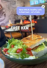 A short promotional video for JJ's Cafe in East Ham, featuring close-up shots of their menu, various sandwiches, bagels, and drinks. The video uses text overlays to highlight the items and the cafe's atmosphere.