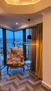 A short, handheld room tour of a hotel room at nhow London, highlighting the quirky interior design, artwork, and city views from the window.