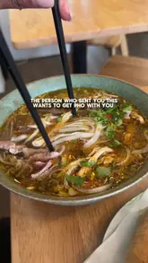A short, punchy food review video showcasing a variety of dishes at a pho restaurant, including pho, spring rolls, chicken wings, and a rice bowl. The video uses quick, handheld cuts to highlight the food's presentation and texture.
