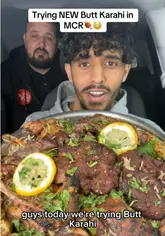 A creator reviews a large mixed grill platter from Butt Karahi in Manchester, sampling various meats including kebabs, chops, and tandoori chicken while sitting in a car.