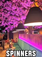 A promotional reel for Spinners in Chester, showcasing the venue's competitive socialising games including electric darts, clay shooting, duckpin bowling, and shuffleboard, alongside food and drinks.