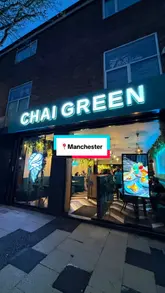 A promotional video showcasing the interior and menu offerings of Chai Green, featuring a variety of dishes including seekh kebab rolls, butter chicken, noodles, and desserts, alongside mocktails and chai.
