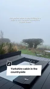 A short, atmospheric montage showcasing a cabin stay in the Yorkshire countryside, highlighting features like an outdoor bathtub, cozy interior with a fireplace, and scenic views.