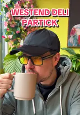 Two creators visit Westend Deli in Partick, Glasgow, for a brunch review. They showcase the interior, order coffee, hot chocolate, a halloumi stack, and a black pudding stack, providing commentary on the quality of the food and the atmosphere.