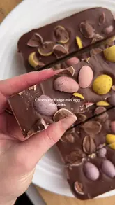 A clear, top-down recipe tutorial for chocolate fudge mini egg flapjacks, showing the preparation of the oat base, baking, and the addition of the chocolate topping and mini eggs.