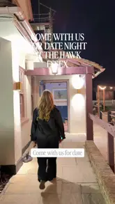 A couple visits The Hawk in Battlesbridge, Essex, to experience its recent refurbishment. The video follows them through the venue, highlighting the cozy atmosphere, drinks, and a variety of dishes including scallops, prawns, seafood pasta, and steak.