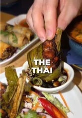 The video features two creators visiting a local Thai restaurant to highlight its authentic food and encourage support for the business. It includes shots of the kitchen, close-ups of various dishes like spring rolls and pad thai, and the creators sharing their experience.