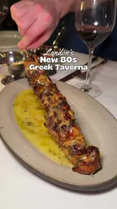 A review of Maza, a new 80s-inspired Greek restaurant in Mayfair, London, showcasing the interior, cocktails, and various dishes including calamari, souvlaki, and desserts.