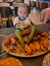 A personal vlog-style review of a Turkish restaurant in North London, featuring a family dining experience. The video highlights a large mixed grill platter, lahmacun, and vegetarian pide, showcasing the food and the casual, family-friendly atmosphere.