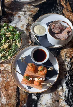 Okay, assuming the image shows a Pan-Asian bottomless brunch spread at an Essex restaurant:

**Delicious Pan-Asian bottomless brunch spread with cocktails at an Essex restaurant, ideal for a special occasion. Essex food.** (122 characters)