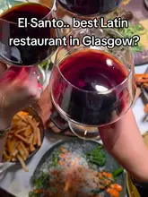 A review of El Santo in Glasgow, featuring a variety of Latin American dishes including table-side guacamole, steaks, lamb chops, and creative desserts like a chocolate cigar. The video captures the vibrant, dimly lit atmosphere and the cocktail experience, positioning it as a strong choice for social dining.