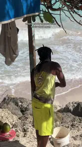 A short, handheld video showing a beach vendor preparing a fresh coconut for a customer to drink, highlighting the authenticity of the experience.