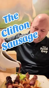 A couple visits The Clifton Sausage in Bristol, reviewing various dishes including Cornish mussels, crispy spicy cauliflower, a sausage tasting plate, and slow-roasted pork belly, while providing commentary on the atmosphere and service.