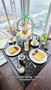 A high-quality, visually appealing reel showcasing the Spring-Summer afternoon tea service at TĪNG in the Shangri-La The Shard. The video features close-ups of the tiered food display, including sandwiches, scones, and pastries, alongside cocktails and tea, all set against the backdrop of panoramic London skyline views.