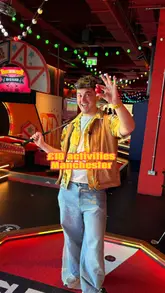 A creator visits Putters at Urban Playground in Manchester's Arndale Centre to review their £10 mini-golf experience. The video highlights the tech-enabled scoring system, the fun atmosphere, and the affordability of the activity, ending with a drink.