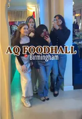 A food blogger visits AQ Foodhall in Birmingham, highlighting several vendors including Fat Belly, Kohitayn, Frost + Froth, and Kacao. The video features the creator trying various items like a white chocolate matcha, a hot honey chicken pocket toast, frozen yogurt, and a pistachio milk cake, while also showcasing the venue's social atmosphere, arcade games, and photo booth.