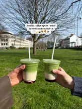 A first-person perspective shot of two people holding matcha lattes in a park, serving as the cover image for a listicle-style post about various food and coffee spots in Newcastle.