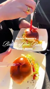 The video is a fast-paced vlog covering a 'Battle of the Burger' food event held at Wylam Brewery. It features a variety of food trucks, showcasing different burgers, fries, and frozen margaritas. The creator guides the viewer through the event, highlighting specific vendors like Scranners Arms, Hake, and Smoke and Sear, while capturing the outdoor, social atmosphere of the bank holiday event.