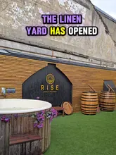 The video provides a quick tour of 'The Linen Yard' in Harold's Cross, highlighting its wellness facilities including hot tubs, saunas, and plunge pools, alongside a variety of food trucks offering pizza, coffee, churros, and poke, plus a bar area.