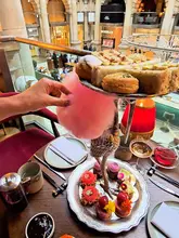 A high-quality, polished reel showcasing the Cherry Blossom Afternoon Tea at Jang, located within the historic Royal Exchange in London. The video features sweeping shots of the venue's architecture, close-ups of the intricate patisserie, and the service of the tea, creating an inviting and luxurious atmosphere.