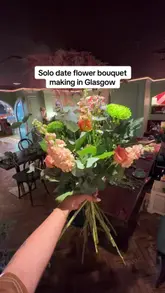A vlog-style video showing a creator attending a flower bouquet-making workshop at The Delphine, a cafe and bar venue. The video follows the process of selecting flowers, arranging the bouquet, and wrapping it, highlighting the venue as a space for creative activities.