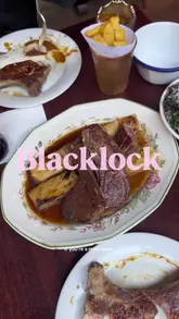 A couple visits Blacklock, a British chop house, to try their 'All In' platter, which includes beef, pork, and lamb, along with various sides and a white chocolate cheesecake dessert.