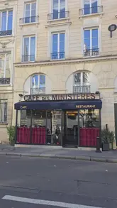 The video is a review of Café des Ministères in Paris, focusing on their signature Vol-Au-Vent with veal sweetbreads. The creator provides a personal, enthusiastic commentary while showcasing various dishes, including duck foie gras terrine, scallops with duchess potatoes, and a chocolate fondant dessert. The video includes shots of the menu, the bill, and the restaurant's interior, providing a comprehensive look at the dining experience.