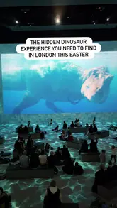 A promotional video for the Prehistoric Planet: Discovering Dinosaurs immersive exhibition at Lightroom in King's Cross, London. The video showcases various scenes from the 360-degree projection, including dinosaurs in different environments, and briefly highlights the venue's gift shop and cafe.