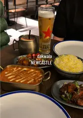A promotional video for Dakwala Bombay Canteen's 2nd birthday bottomless brunch, featuring a variety of cocktails and Indian dishes like butter chicken and chilli manchurian.