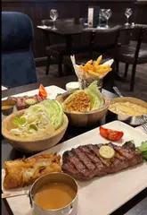 A montage showcasing the interior and food offerings at a Miller & Carter steakhouse, highlighting their Valentine's Day set menu.
