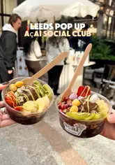 A short, handheld video showcasing an açai bowl pop-up stall located in a Leeds shopping arcade. The video features quick cuts of the menu, the preparation process, and the final product, effectively highlighting the offering to potential customers.